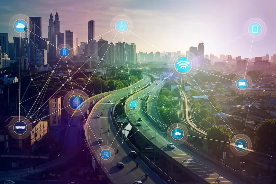 View of city skyline with overlay of icons indicating smart city connectivity.